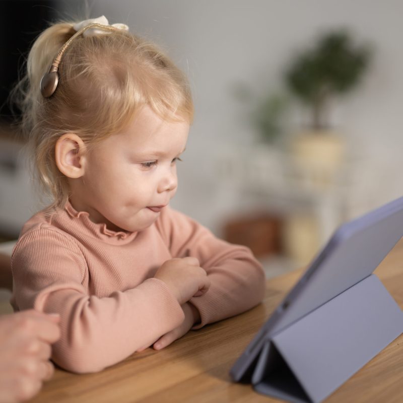 Deaf kid with hearing aid cochlear implant - Hear aid and medicine innovating technology and diversity